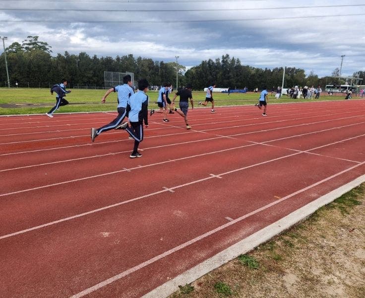 An image of students running on the track for the athletics carnival.
