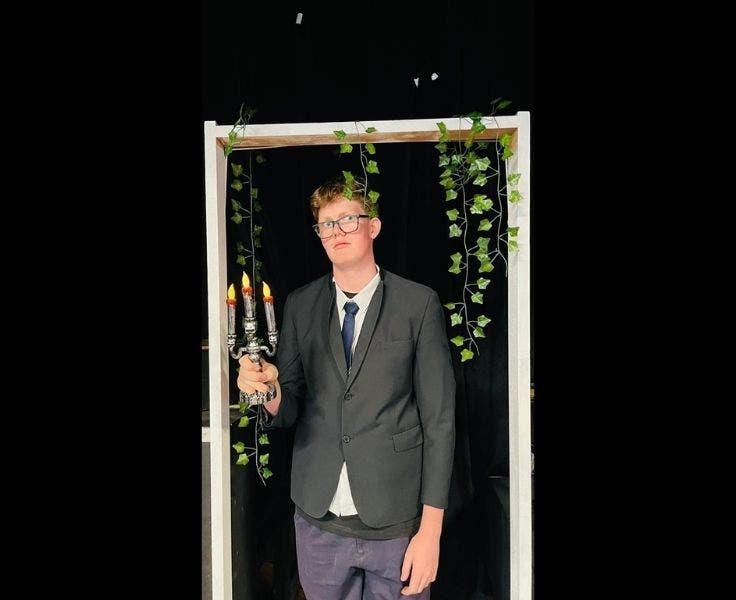 An image of a student in their costume ready to preform in the school musical.